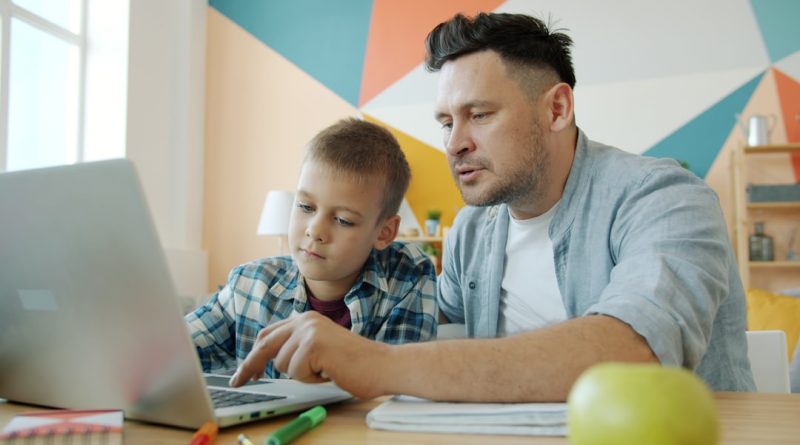 A teacher supporting a student with reading using personalized technology tools in a classroom setting