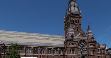 Historic Cambridge University college courtyard with stone architecture and green lawns