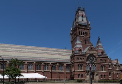 Historic Cambridge University college courtyard with stone architecture and green lawns