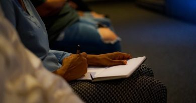 Student reviewing scholarship and financial aid documents while studying