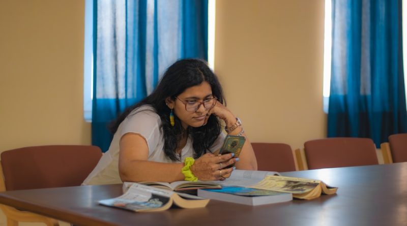 Student reviewing education financing documents and loan options at desk