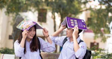 High school students looking through yearbook pages together