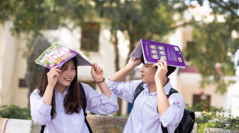 High school students looking through yearbook pages together