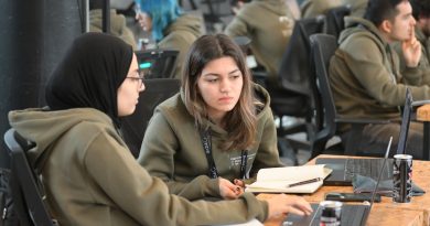 Diverse students engaged in humanities research and academic discussion