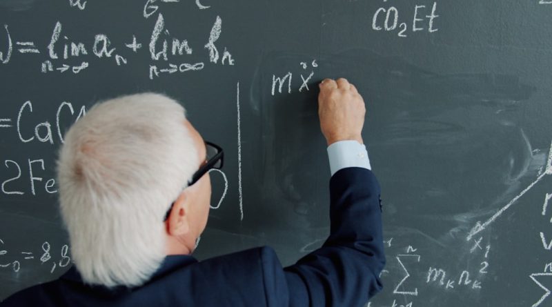 Students and teacher engaged in collaborative mathematics lesson in modern classroom