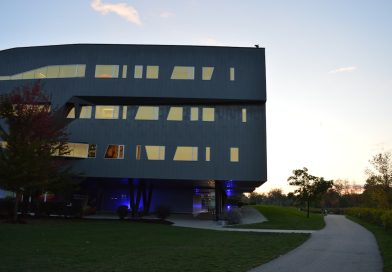 MIT campus with modern buildings and students studying