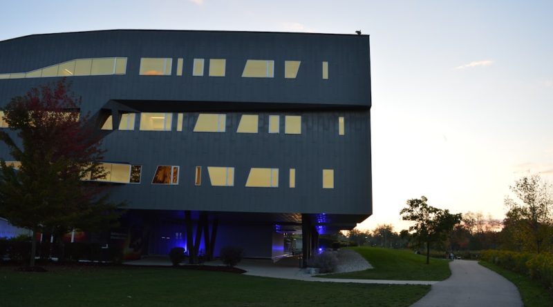 MIT campus with modern buildings and students studying