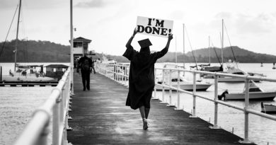 Students celebrating graduation at community college ceremony
