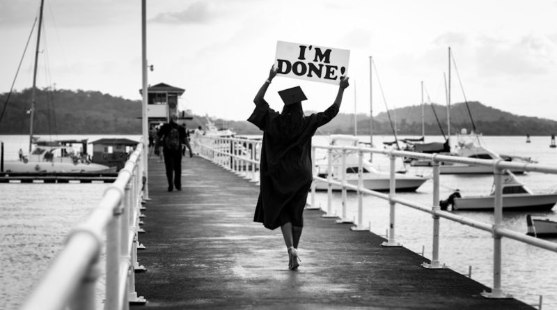 Students celebrating graduation at community college ceremony