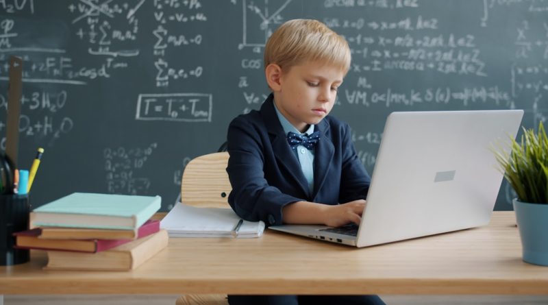 Student studying with school supplies and books on desk