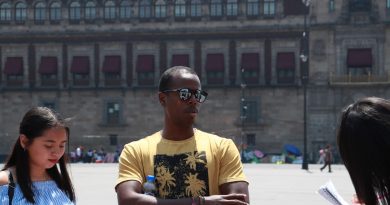 International student studying at desk with laptop and books