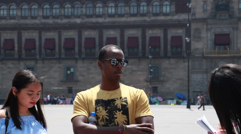 International student studying at desk with laptop and books