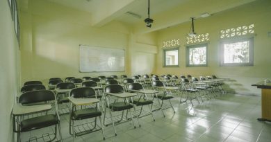 Modern university classroom with students and professor using technology for interactive learning
