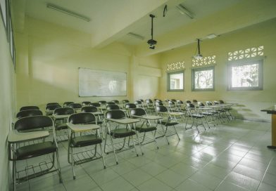 Modern university classroom with students and professor using technology for interactive learning
