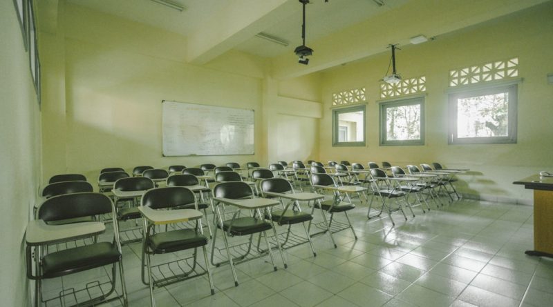 Modern university classroom with students and professor using technology for interactive learning
