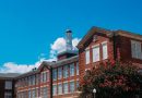 Modern university campus building with students walking across grounds