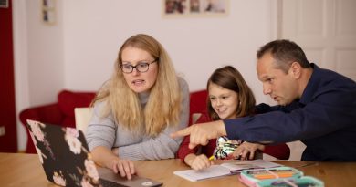 A tutor working with a student on reading and literacy skills during classroom tutoring session