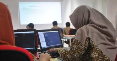 University professor teaching artificial intelligence and machine learning to students in modern computer science classroom