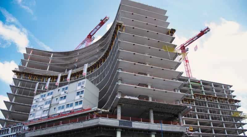 Modern children's hospital building under construction with cranes