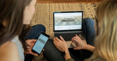 Student working on college application and financial aid forms on laptop