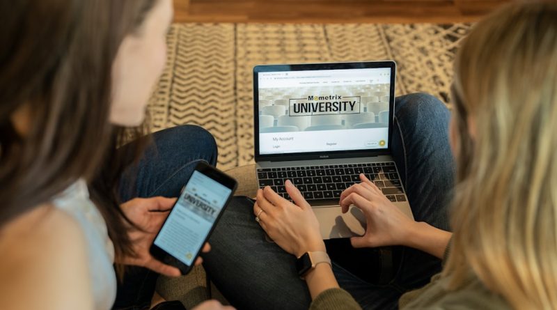 Student working on college application and financial aid forms on laptop