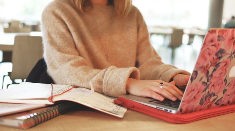 Indian student studying abroad with laptop and financial documents