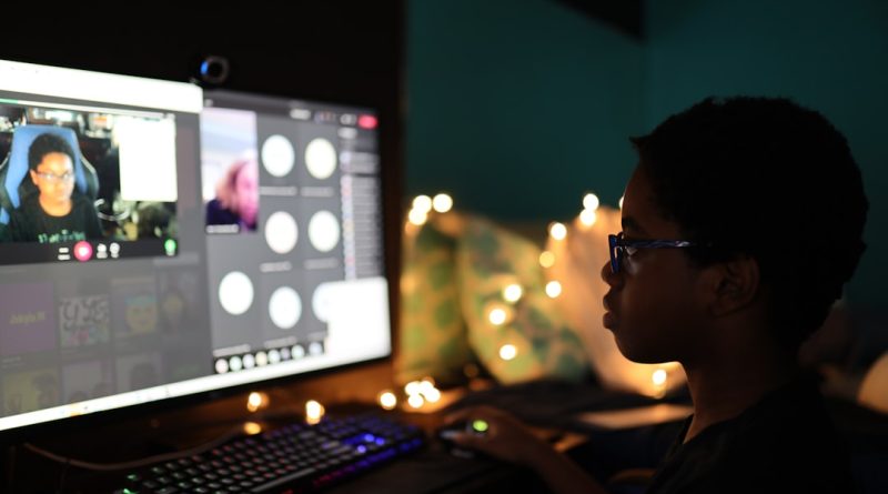Young student engaged in educational gaming on computer
