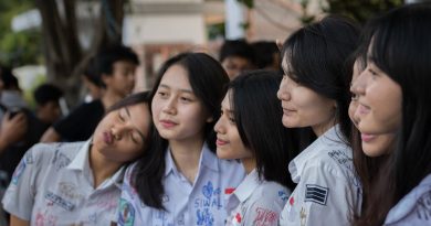 Graduate nurses in caps and gowns celebrating their completion of dual-degree program