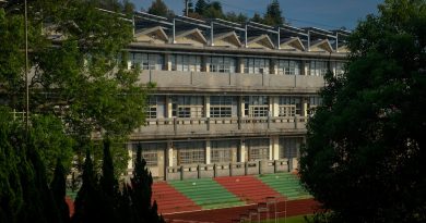 Modern charter school building with students walking outside