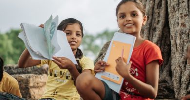 Minister discussing sustainable education policies at National Education Day event