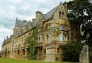 Historic Oxford University college building with students walking across the quadrangle