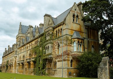 Historic Oxford University college building with students walking across the quadrangle
