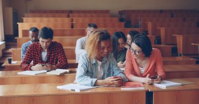 Students using smartphones in classroom during lesson