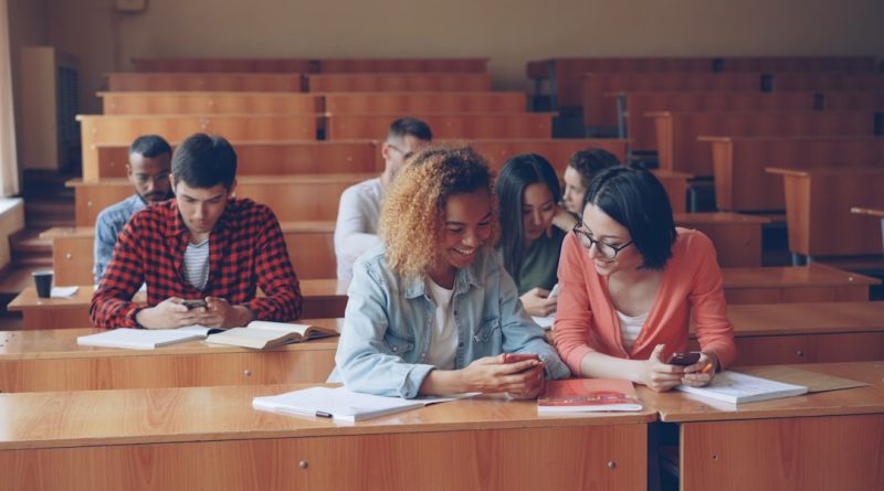 Students using smartphones in classroom during lesson