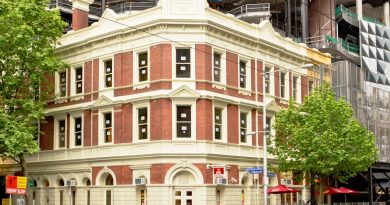 Modern student accommodation building in Melbourne CBD with city skyline