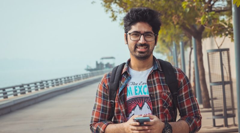 Indian student studying abroad with laptop and books
