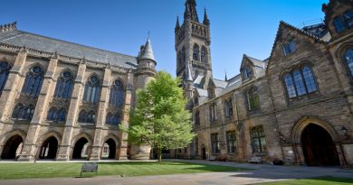 Indian students studying at UK university with books and laptops