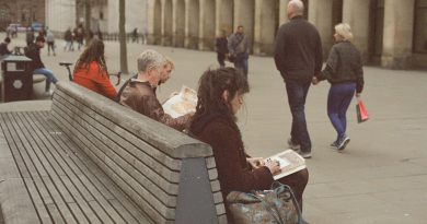 Indian students studying at UK university campus with books and laptop