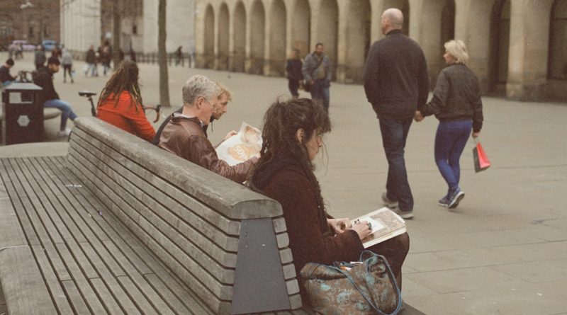 Indian students studying at UK university campus with books and laptop