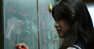 Student focusing on writing with pen and paper before using AI tools