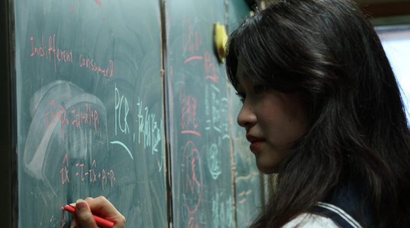 Student focusing on writing with pen and paper before using AI tools