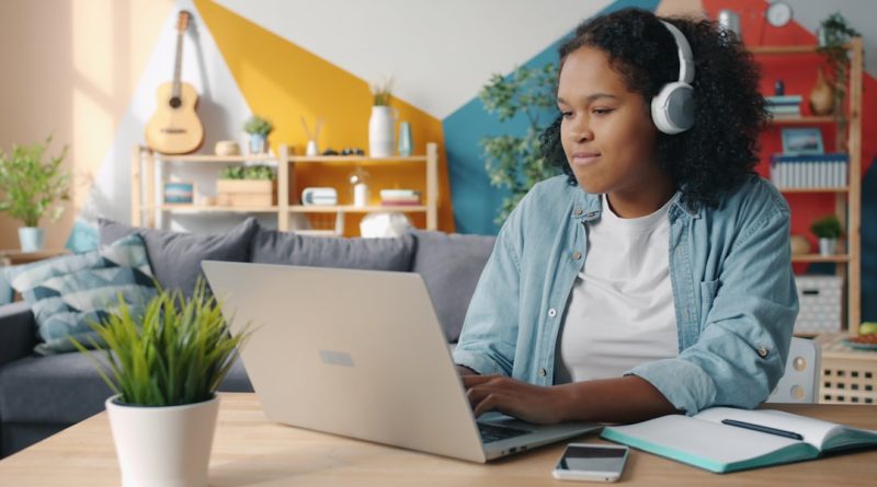 Diverse group of students engaging with AI learning tools in a modern classroom environment